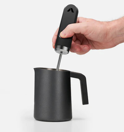 Churn warm milk with NanoFoamer for approximately 15 seconds